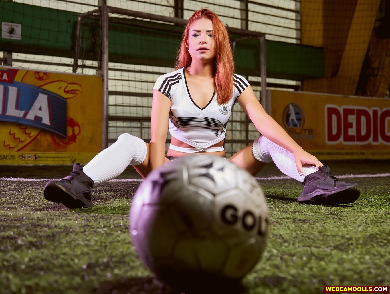 Redhead Teen Girl sitting on Football Field in White Knee High Socks on Webcamdolls