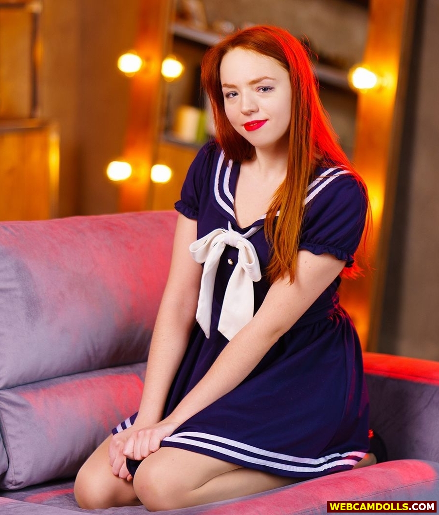 Redhead Schoolgirl kneeling in Blue Short Dress on Webcamsdolls
