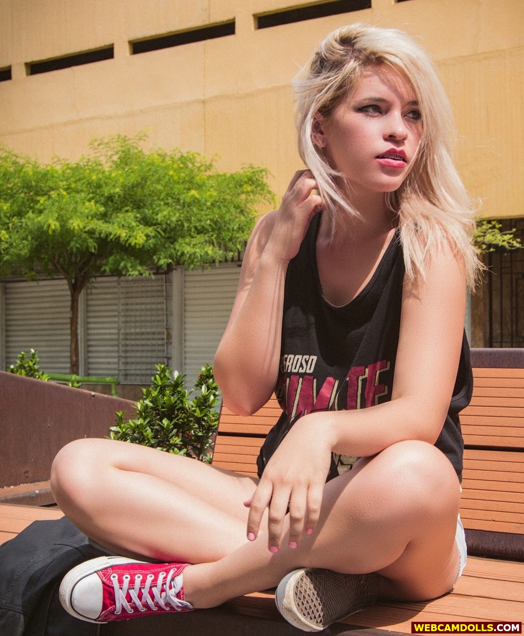 Blonde Girl sitting Crossed Legs in Red Sneakers on Webcamdolls