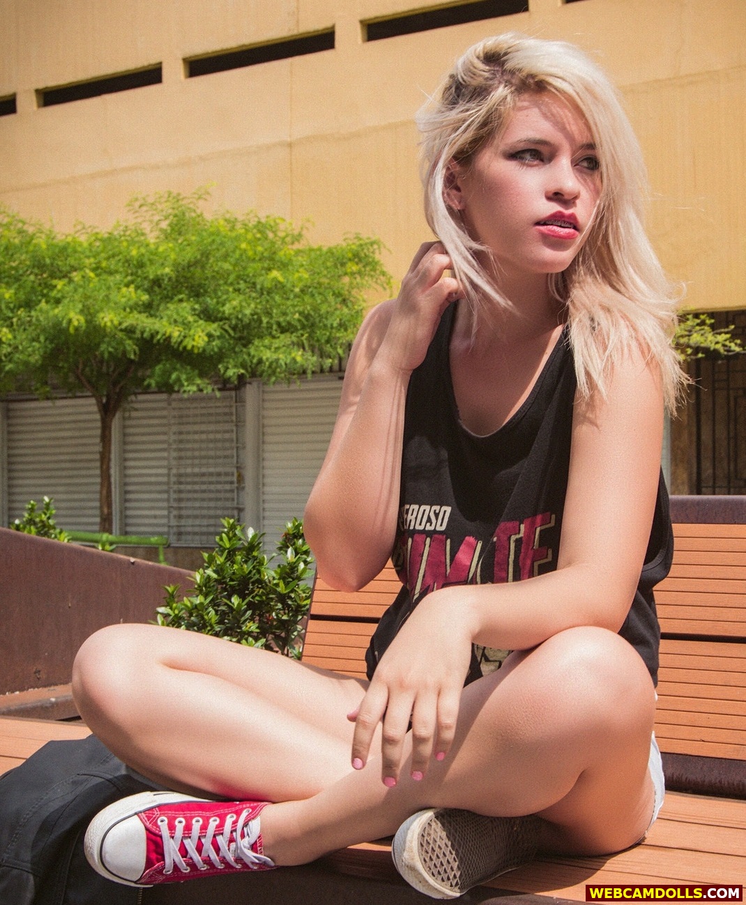 Blonde Girl sitting Crossed Legs in Red Sneakers on Webcamdolls