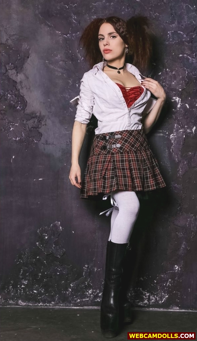 Teen Girl wearing Tartan Pleated Mini Skirt and Black Shiny Boots on Webcamdolls